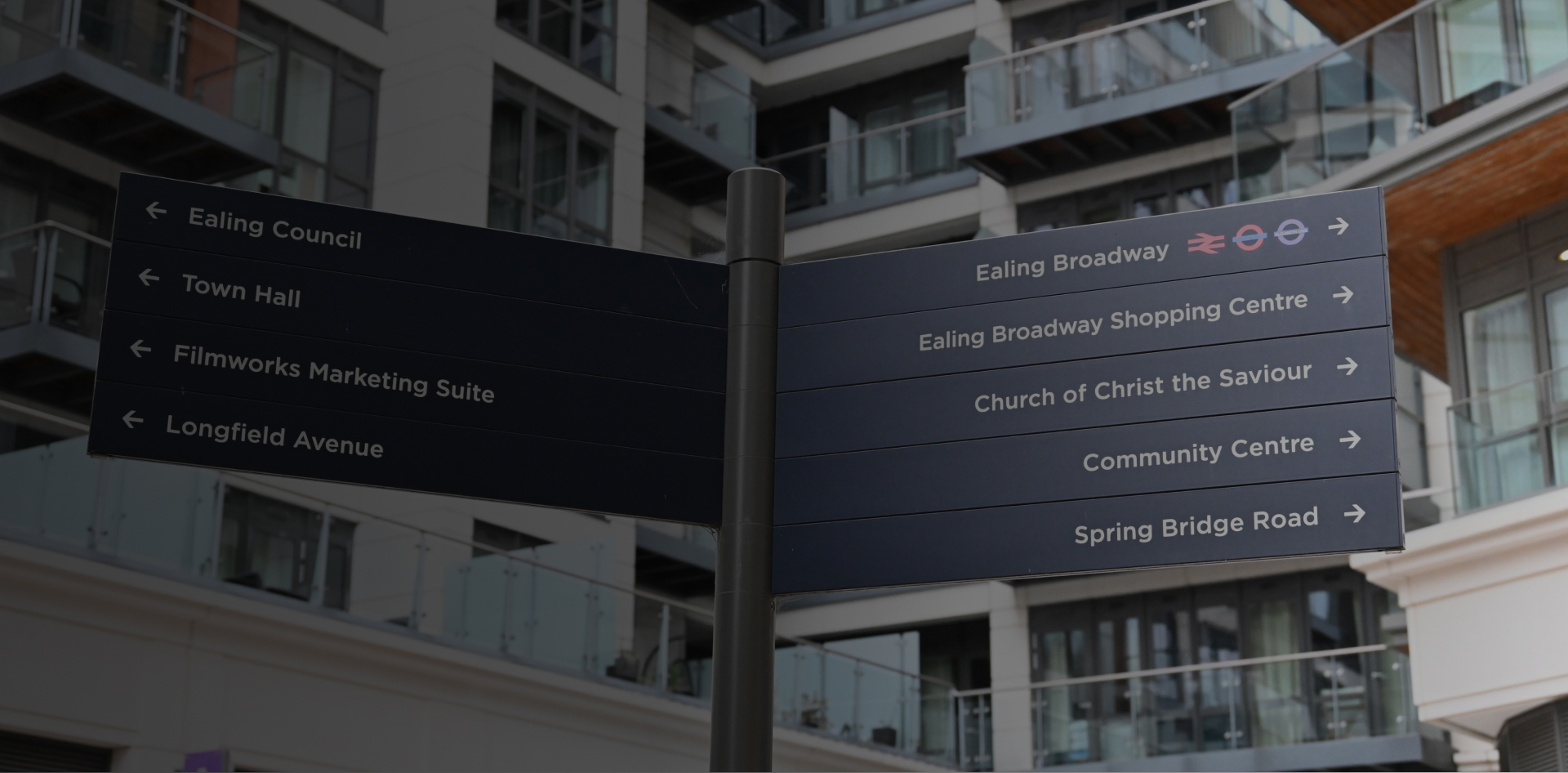 A lamp post with directions on it in Central Ealing