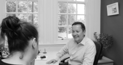 Dean talking to a customer, smiling