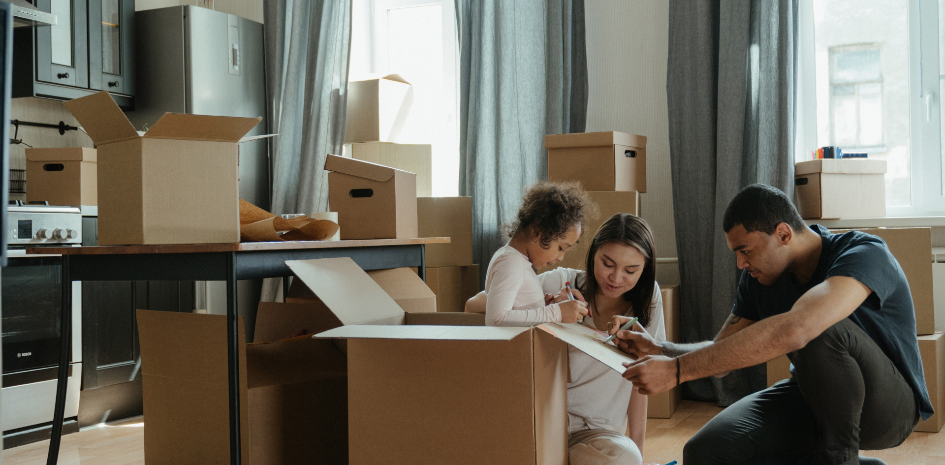 A family unpacking removal boxes
